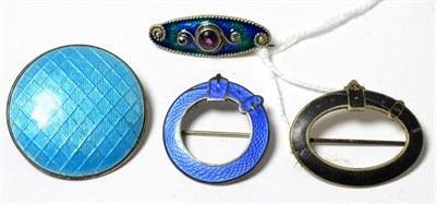 Lot 65 - A silver enamel and purple paste set brooch and three other enamel brooches (4)