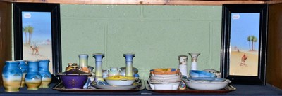 Lot 142 - A shelf of Noritake, mostly on a blue ground and a pair of watercolours of figures and camels...