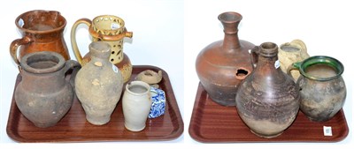 Lot 155 - A 19th century stoneware puzzle jug, pottery flagons, jars etc (on two trays)