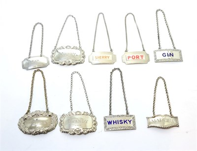 Lot 218 - Eight silver bottle labels, including four enamelled examples and one further plated example