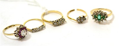 Lot 291 - A 9ct gold three stone diamond ring, another three stone diamond ring and three other dress rings