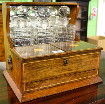 Lot 347 - Early 20th century inlaid oak combination tantalus with three bottles and games