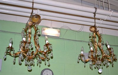 Lot 360 - A pair of gilt metal and glass drop chandeliers