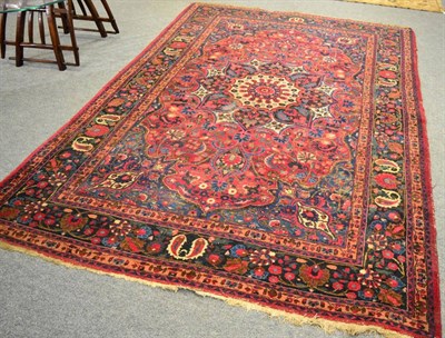 Lot 1092 - A Moud Carpet, North East Iran, The raspberry field of floral vines around a flowerhead...