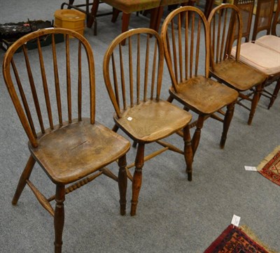 Lot 1095 - A composite set of four 19th century spindle back chairs, elm seated turned legs and stretcher (4)