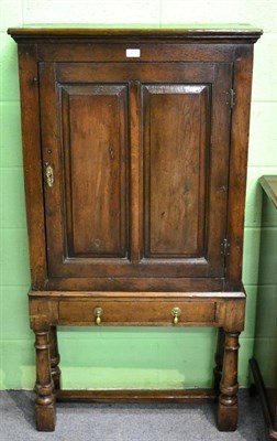 Lot 1210 - An 18th century oak cupboard on later stand