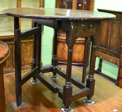 Lot 1221 - A 19th century oak drop leaf gateleg table