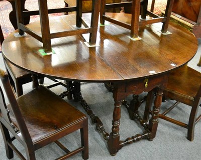 Lot 1236 - An early 18th Century oak drop leaf gateleg table, with two drawers, raised on baluster turned legs