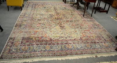 Lot 1249 - Kirman Carpet, South East Iran, the pale mint field of vines centred by a raspberry medallion...