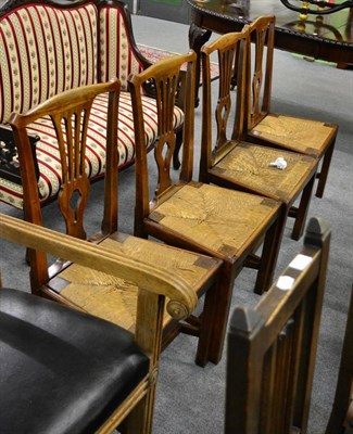 Lot 1260 - A set of four late George III oak framed country dining chairs in the Chippendale style