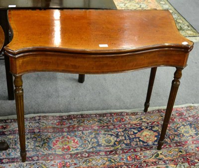 Lot 1285 - A 19th century cross banded satin wood fold over card table on later mahogany legs