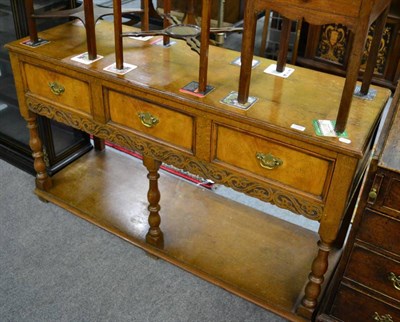 Lot 1296 - A 20th century oak dresser base with three drawers