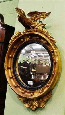 Lot 1312 - Gilt circular wall mirror mounted with an eagle