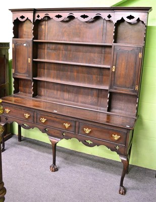 Lot 1320 - A 1920/30's oak dresser, the rack of inverted breakfront form with two cupboard doors and fixed...