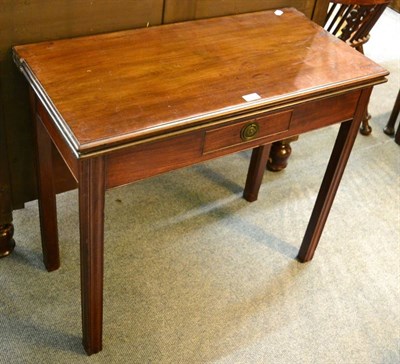 Lot 1335 - A 19th century mahogany fold over tea table