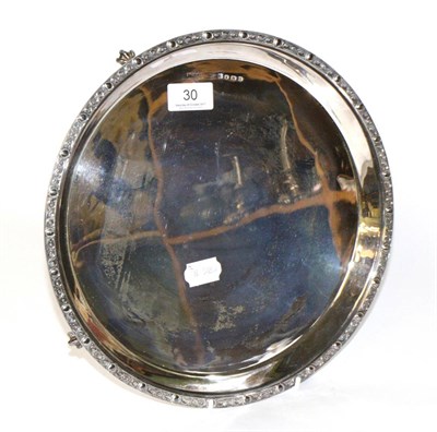 Lot 30 - A silver salver, Sheffield, 1943, relief border, on four claw supports, 30cm diameter, 28.1ozt