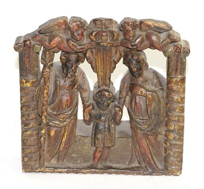 Lot 53 - A Dutch elm carriage panel, circa 1700, carved with the Holy Family below two angels holding a...