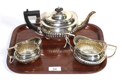 Lot 54 - A composite silver three piece bachelor's teaset, the teapot by Natham & Hayes, Chester, 1908,...