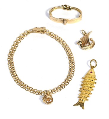 Lot 73 - A yellow metal link bracelet, stamped 18k, with three 9ct gold charms and a 9ct gold toggle