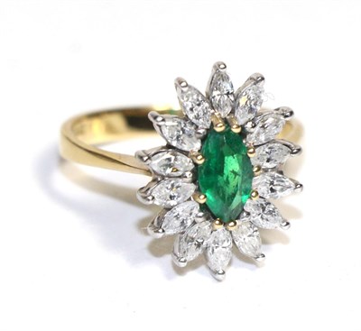 Lot 75 - An 18 carat gold emerald and diamond marquise cluster ring