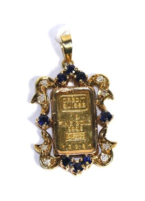 Lot 87 - A 1g 999.9 fine gold ingot in a diamond and sapphire set frame