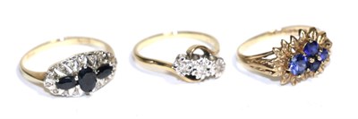 Lot 90 - A diamond three stone twist ring, a 9 carat gold gemset ring and a sapphire and diamond ring (3)