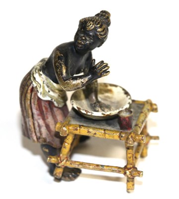 Lot 99 - A gold painted bronze of a negro lady washing