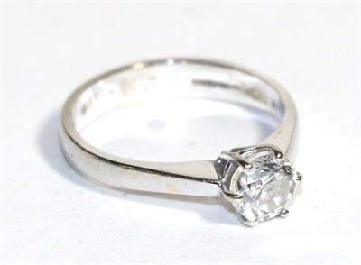 Lot 100 - An 18 carat white gold diamond solitaire ring, a round brilliant cut diamond in a claw setting,...