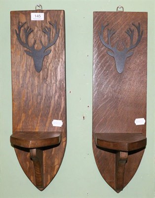 Lot 145 - A pair of oak candle sconces with stag motif