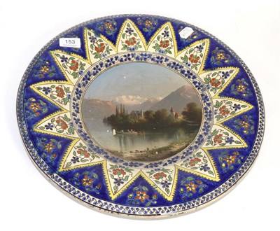 Lot 153 - An A. Born-Straub, Thoune, pottery charger painted with a Swiss lakeland scene within an...