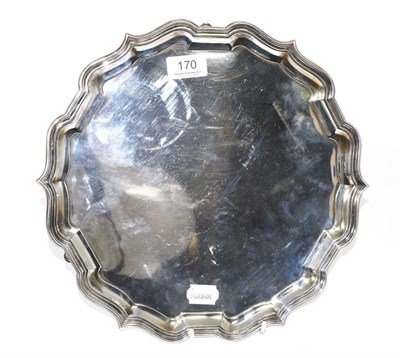 Lot 170 - A Georgian style silver salver, London 1921, retailed by Finnigans Ltd, pierced rim, three...