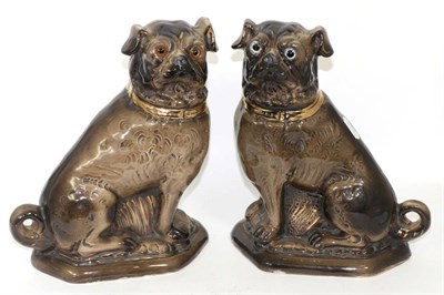 Lot 218 - A pair of 19th century Staffordshire seated pugs with glass eyes