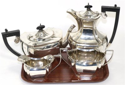 Lot 220 - A four piece silver tea service, K Ltd, Birmingham 1928, of shaped oval form, the hot water jug...