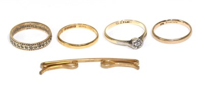 Lot 239 - A solitaire ring, stamped '9ct' and 'PLAT'; with two gold bands and two other items (5)