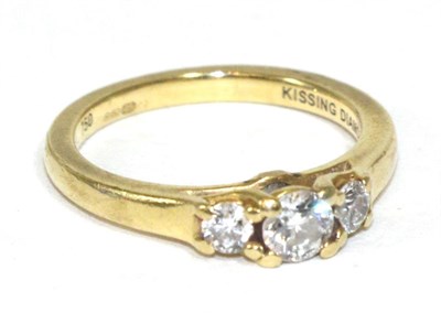 Lot 254 - An 18 carat gold diamond three stone ring, with diamond set gallery