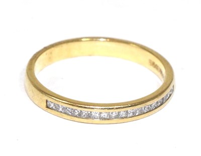 Lot 260 - An 18 carat gold channel set half hoop ring