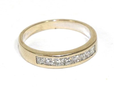 Lot 261 - A princess cut diamond half hoop ring, stamped '750'