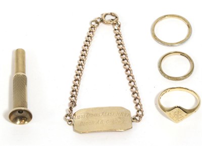 Lot 273 - An identity bracelet, stamped '9ct', three 9 carat gold rings and a 9 carat gold cigar piercer