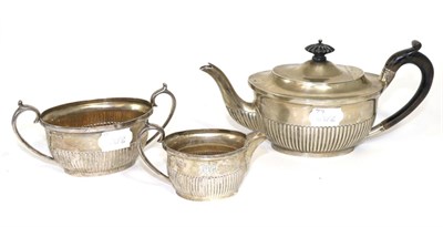 Lot 279 - A late Victorian silver bachelor's three piece tea service, London 1893, of semi-fluted ovoid form