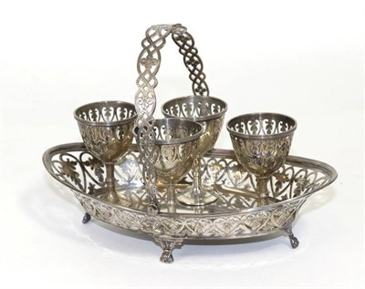 Lot 296 - A silver four piece egg cruet, the stand in the form of a swing handle basket