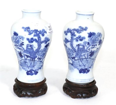 Lot 307 - A pair of 19th century Chinese blue and white vases on hardwood stands