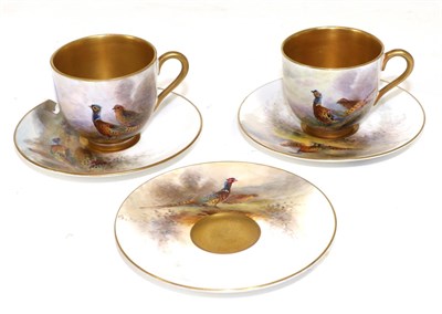 Lot 309 - A pair of Royal Worcester porcelain coffee cups and three saucers painted by James Stinton,...