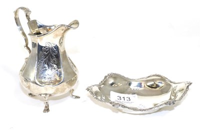 Lot 313 - A Victorian silver cream jug, London marks; together with a silver dish (2)