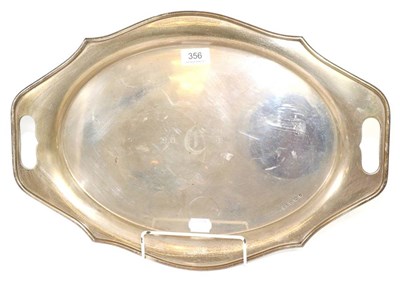 Lot 356 - A twin handled silver tray, Viners Ltd, Sheffield 1932, of shaped oval form, 50cm wide over...