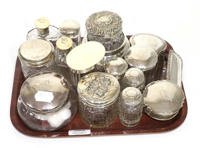 Lot 365 - A group of silver topped dressing table jars, three early 20th century ivory topped examples...