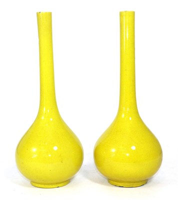 Lot 379 - A pair of Chinese yellow glazed bottle vases