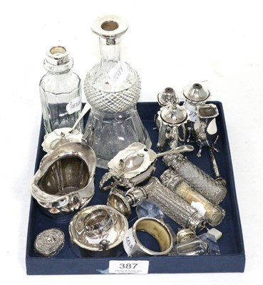 Lot 387 - A collection of silver including various cruets, scents, thistle shaped scent bottle, cream...