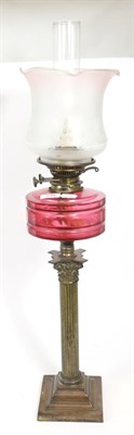 Lot 399 - Cranberry glass and brass oil lamp