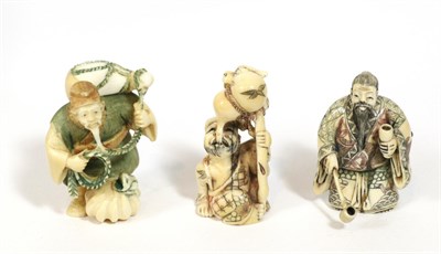 Lot 428 - A Japanese Meiji period ivory netsuke of a water collector inset with three glass cabochons, signed