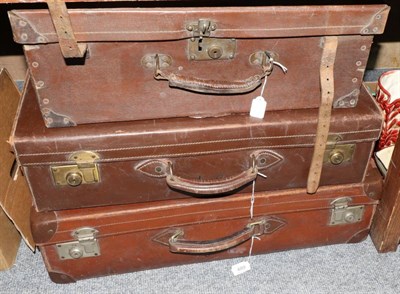 Lot 489 - Three early 20th century suitcases, the two larger examples stamped with initials